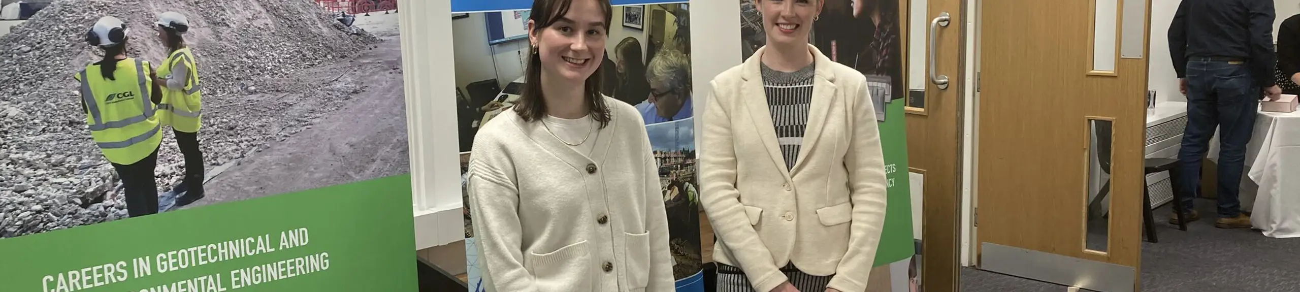 Two women in front of a careers stand Two women in front of a careers stand