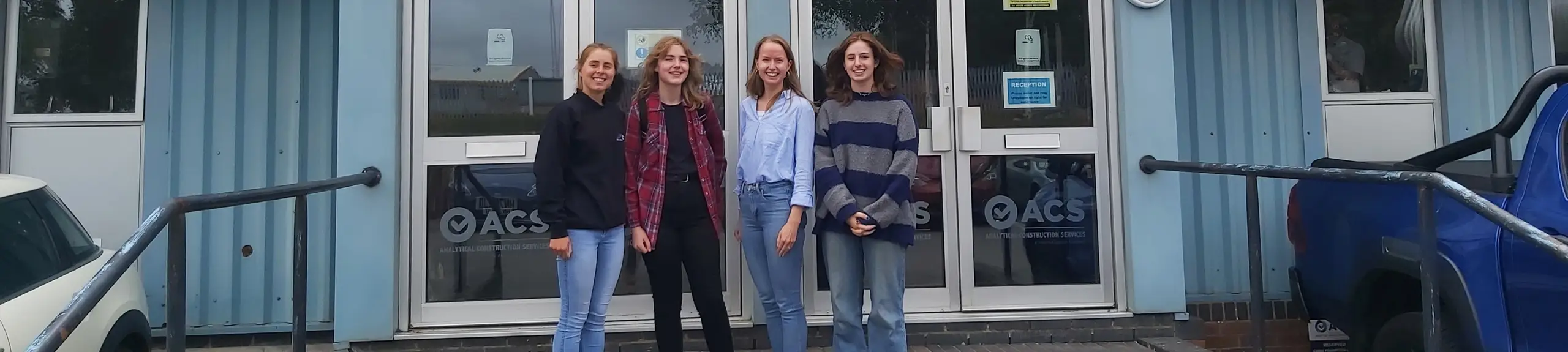 Group standing outside of a lab Group standing outside of a lab
