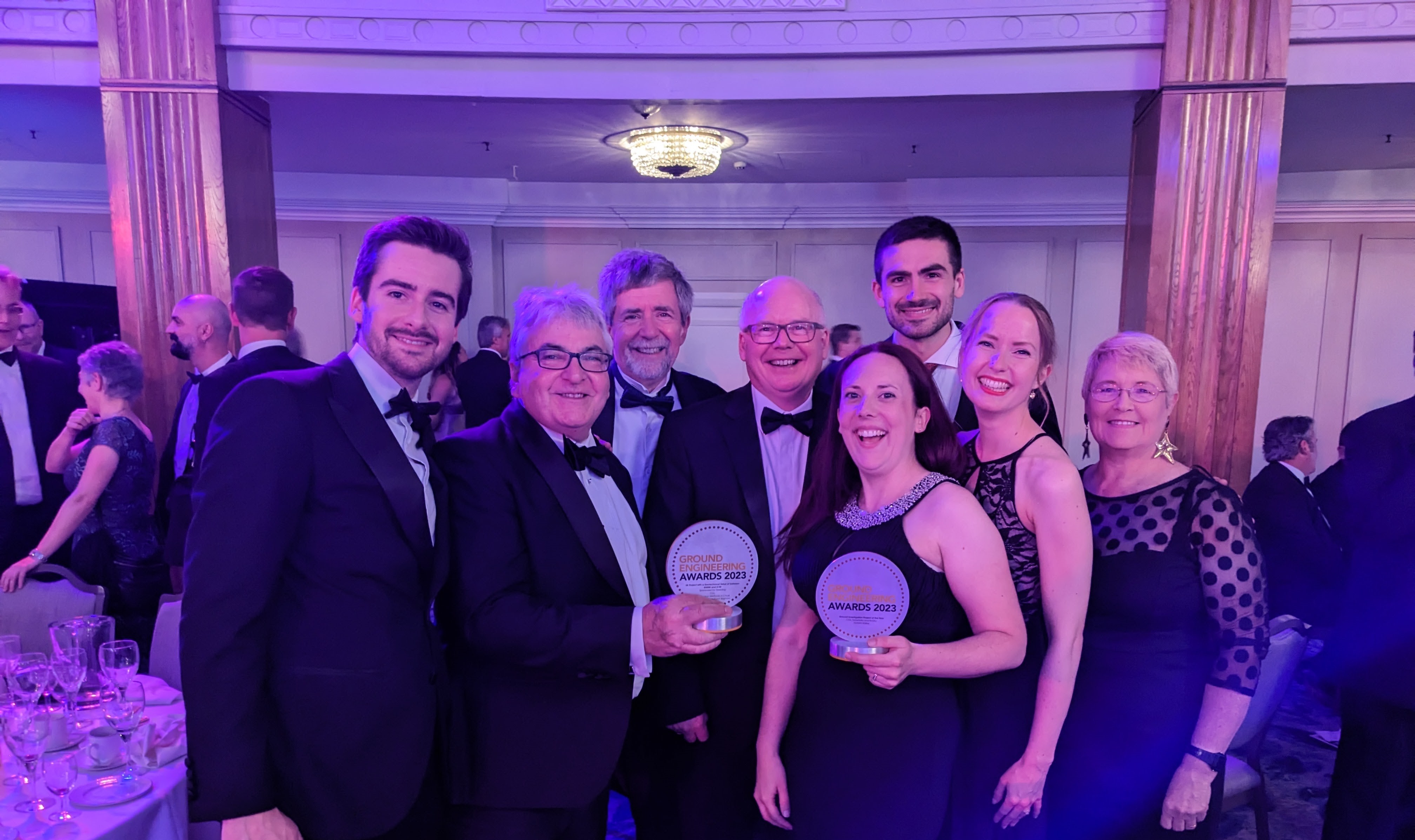 Group dressed formally, holding awards