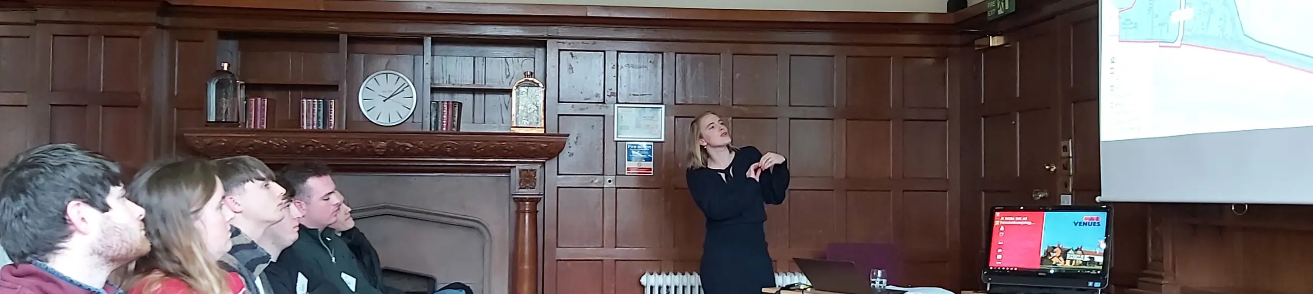 A woman presenting to students A woman presenting to students